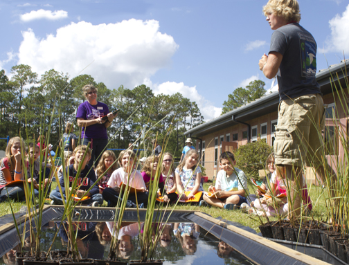 Americorps educator teaches students at Freeport Elementary School about the Choctawhatchee Basin Alliance Grasses in Classes program. Lori Ceier/Walton Outdoors 