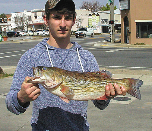 Tucker Martin, 17 with his record setting bass. Photo courtesy Chris Paxton, FWC.