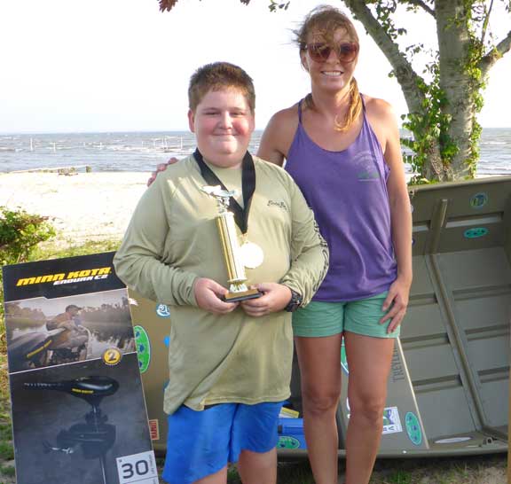 Brandy Foley (R) of Choctawhatchee Basin Alliance is standing with Dalton Taylor, the grand prize winner of a new Tracker Marine Jon Boat and trolling motor.